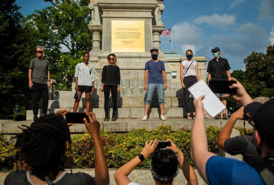 ÒIn honor of George FloydÓ reads the top of a plaque placed by members of a group called Raleigh United, standing together for a group photo, over a Confederate monument on Capitol grounds at the start of the 11th day of protests ignited by the death of George Floyd under the knee of a Minneapolis police officer and since evolved address a wide range of issues in the Black Lives Matter movement, resulting in reforms adopted by the Raleigh Police Department and a task force formed by Gov. Roy Cooper, on Wednesday, Jun. 10, 2020, in Raleigh, N.C.