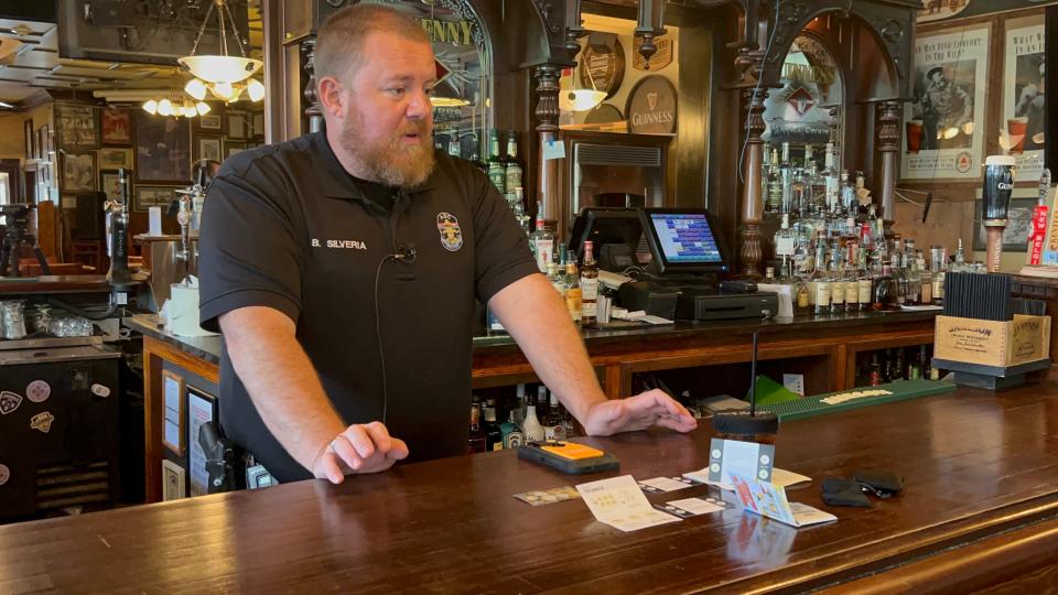 Lt. Brad Silveria explains how the drug testing stickers work at Molly Malone's Irish Pub