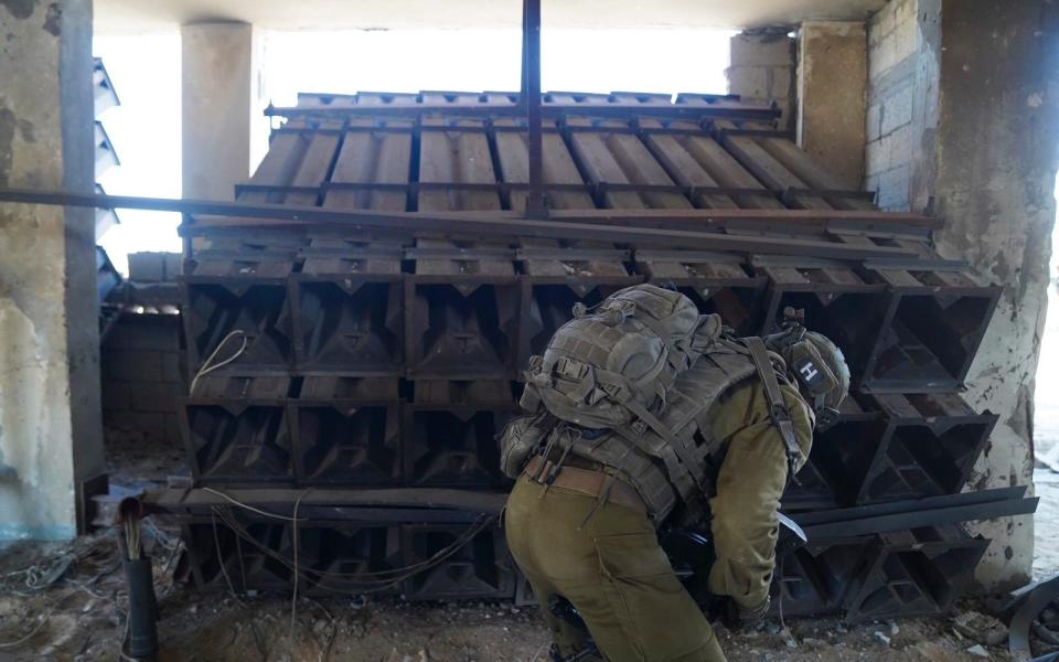 Israeli soldiers check a rocket launcher used by Hamas militants in the Gaza Strip