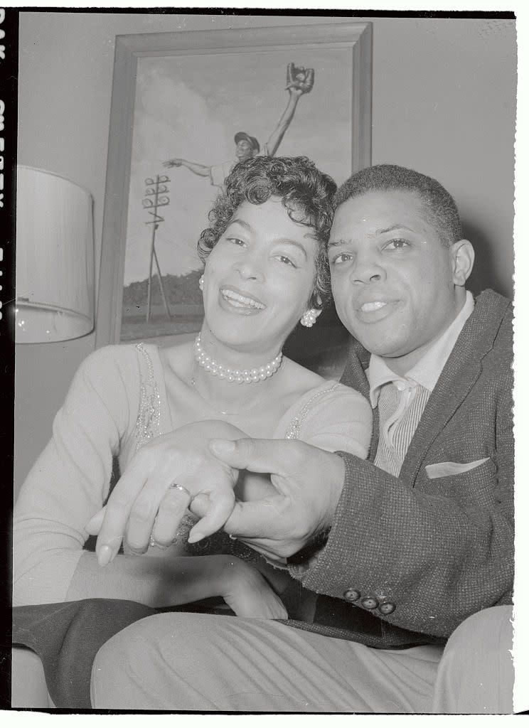 <p>Professional baseball player Willie Mays shows off his wife's wedding band at their home in 1956. They were married until 1963. </p>