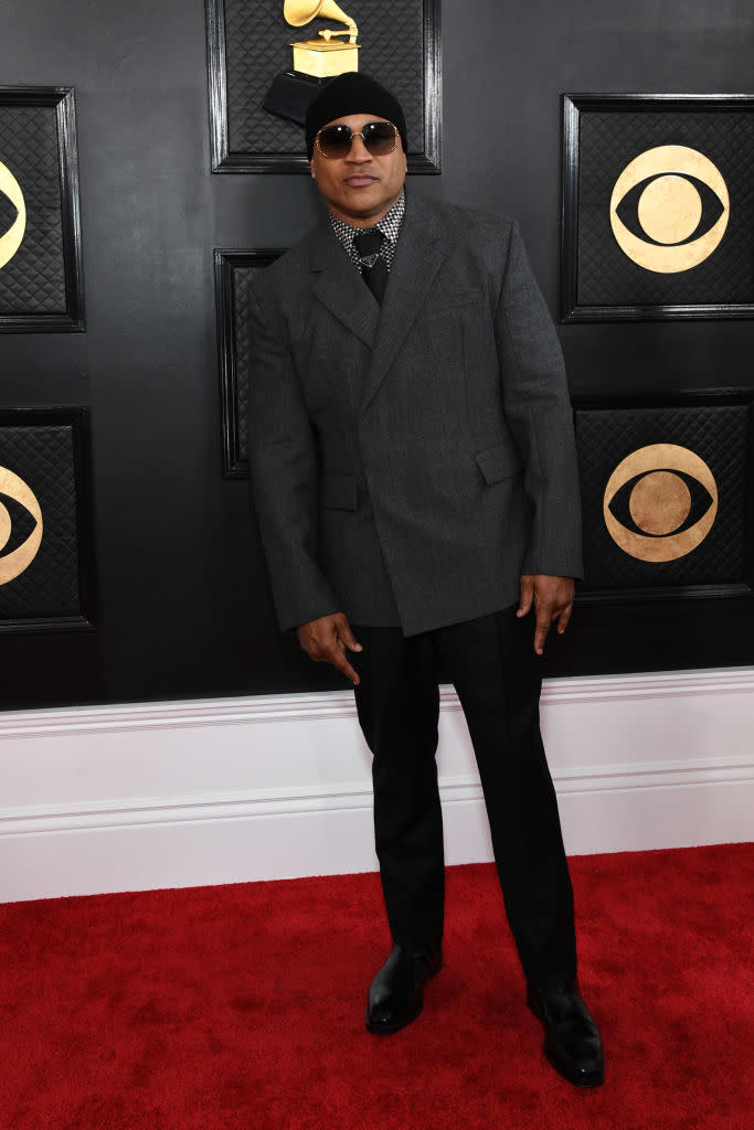 LL Cool J in black had and gray suit.