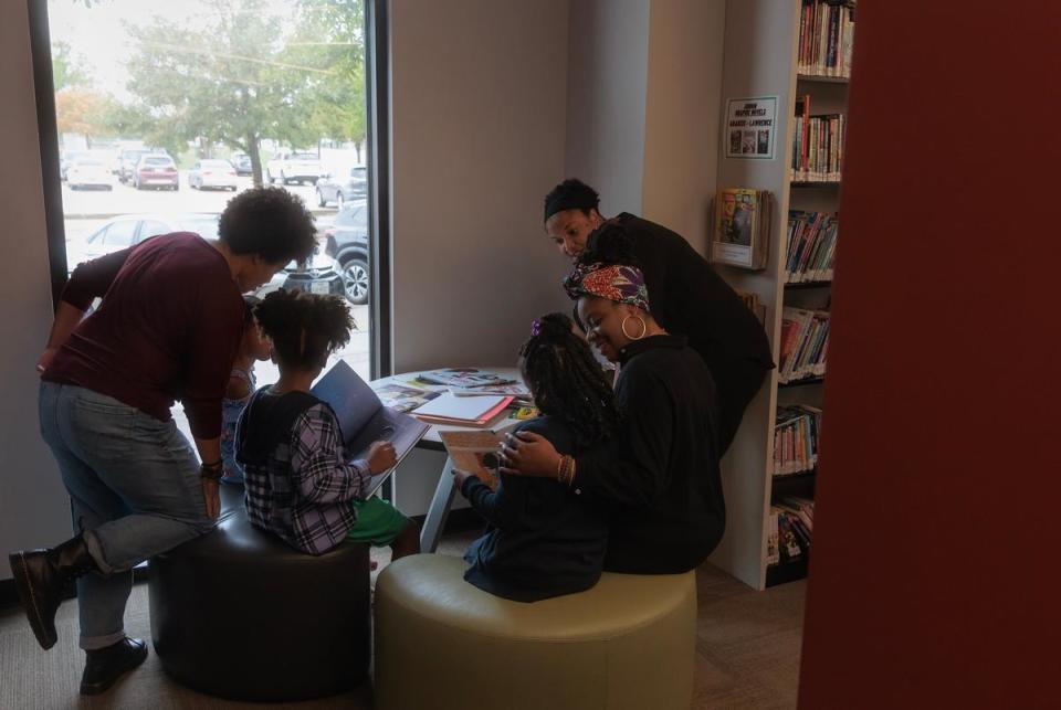 Mothers Anna Sneed, Chantel Jones-Bigby and Sharby Hunt-Hart read books with their daughters at the Rowlett Public Library in Rowlett, TX on October 26, 2023.