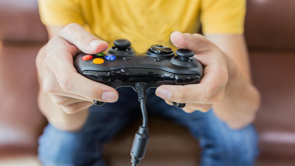 A games console controller held in hands during play