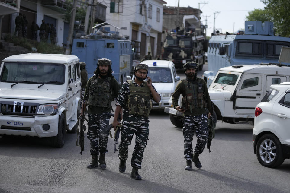 Security officers arrive at the site of an attack in Jammu, India, Friday, April. 22, 2022. Six suspected rebels and an Indian paramilitary officer were killed in two separate armed clashes in Indian-controlled Kashmir, police said on Friday, two days ahead of Prime Minister Narendra Modi's visit to the disputed region.(AP Photo/Channi Anand)