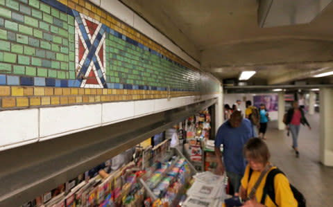 The mosaic tile design meant to represent Times Square's status as the "Crossroads of the World" is part of the subway station's border, in New York - Credit: AP