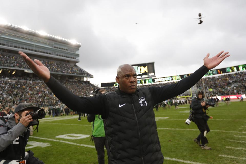 Michigan State head coach Mel Tucker waves at fans  to celebrate their 37-33 win over Michigan  at Spartan Stadium in East Lansing on Saturday, Oct. 30, 2021. 