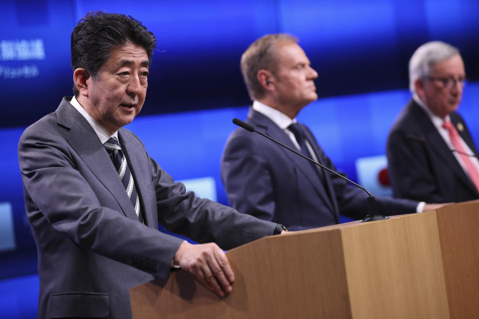 Japan's Prime Minister Shinzo Abe, left, talks to journalists during a joint news conference with European Commission President Jean-Claude Juncker, right, and European Council President Donald Tusk following their meeting during an EU-Japan summit at the European Council headquarters in Brussels, Thursday, April 25, 2019. Japanese Prime Minister Shinzo Abe and top EU officials discussed trade, bilateral ties and North Korea. (AP Photo/Francisco Seco)