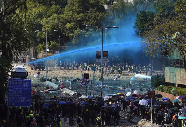 Police spray protesters with blue-dyed liquid