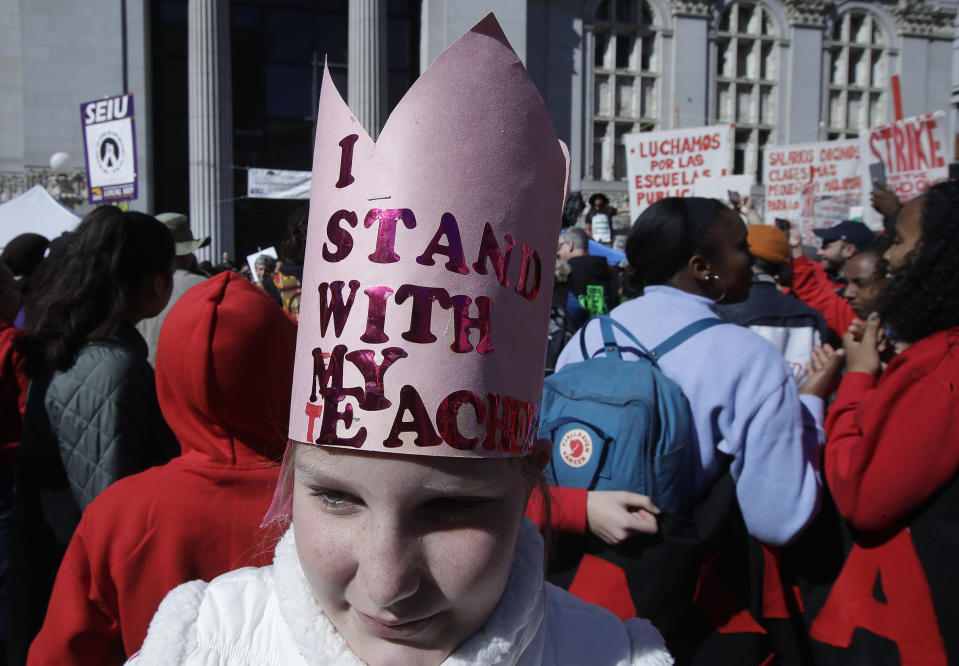 Glenview Elementary student Aniko English wears a hat in support of teachers at a rally at Frank Ogawa Plaza in front of City Hall in Oakland, Calif., Thursday, Feb. 21, 2019. Teachers in Oakland, California, went on strike Thursday in the country's latest walkout by educators over classroom conditions and pay. (AP Photo/Jeff Chiu)