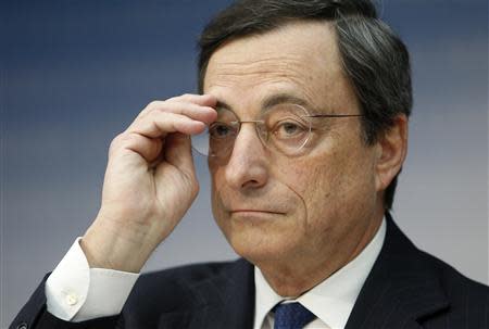 European Central Bank (ECB) President Mario Draghi adjusts his glasses during the monthly ECB news conference in Frankfurt December 6, 2012. REUTERS/Lisi Niesner