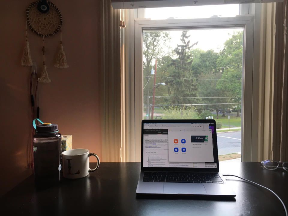 The author's desk and laptop with the Zoom app and Blackboard open<span class="copyright">Courtesy Jimin Kang</span>