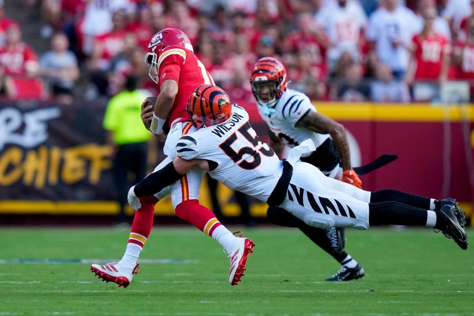 Cincinnati Bengals linebacker Logan Wilson wraps up Kansas City Chiefs quarterback Patrick Mahomes