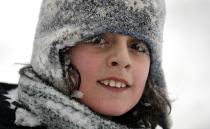 Alberto Siniscalco is pictured with frozen eyelashes while tobogganing during a snow storm in Toronto, December 14, 2013. Approximately 15 to 20 cm of snow may fall by Sunday morning for areas near the Lakeshore in Toronto and Mississauga, according to weather forecaster Environment Canada. REUTERS/Aaron Harris (CANADA - Tags: ENVIRONMENT SOCIETY)