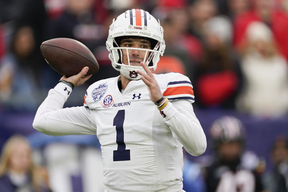 FILE - Auburn quarterback Payton Thorne looks to throw a pass during the first half of the Music City Bowl NCAA college football game against Maryland, Dec. 30, 2023, in Nashville, Tenn. The Auburn Tigers have a new offensive coordinator, new wide receivers and renewed competition at quarterback. (AP Photo/George Walker IV, File)