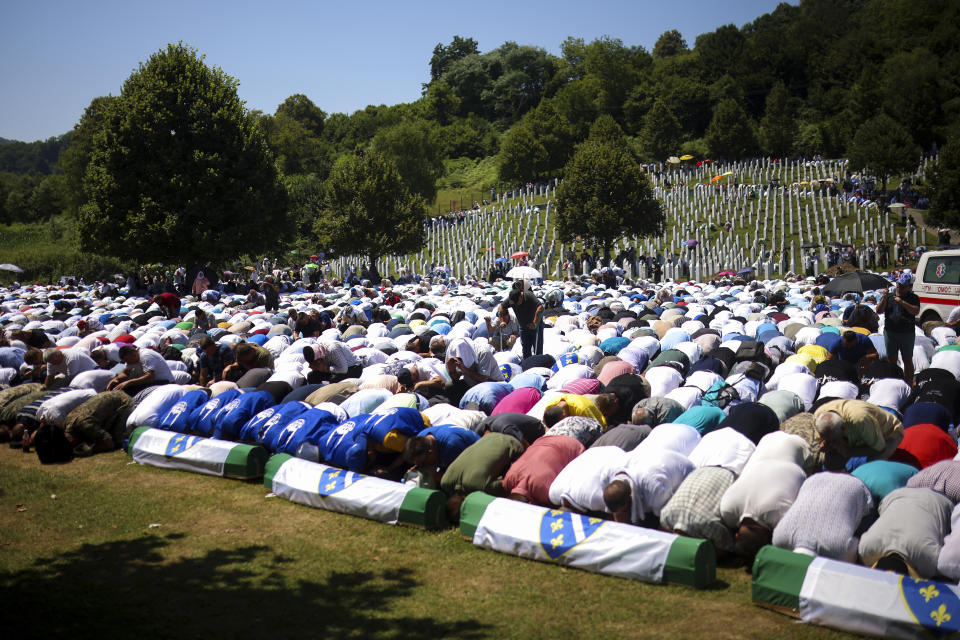 Bosnian muslim man pray during the mass burial ceremony for the 14 newly identified victims of the Srebrenica genocide, at the Srebrenica Memorial Centre, in Potocari, Bosnia, Thursday, July 11, 2024. Thousands gather in the eastern Bosnian town of Srebrenica to commemorate the 29th anniversary on Monday of Europe's only acknowledged genocide since World War II. (AP Photo/Armin Durgut)