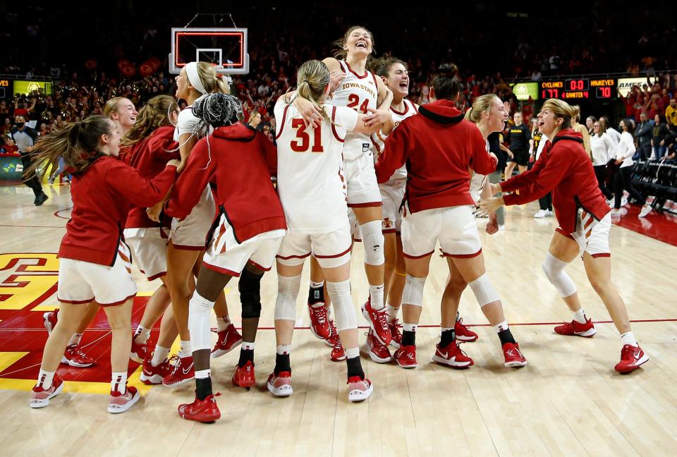 Members of the Iowa State women&#39;s basketball team, including leading scorer Ashley Joens (24), celebrate after beating Iowa 77-70 on Wednesday at Hilton Coliseum in Ames.