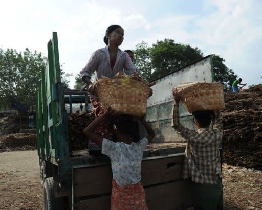 Women load wood into a truck to later be sold as firewood in Myanmar. A US ban on all Myanmar imports is stifling key job-creating areas of the economy such as the garment industry rather than hurting the interests of the corrupt elite it targets, a report said Friday