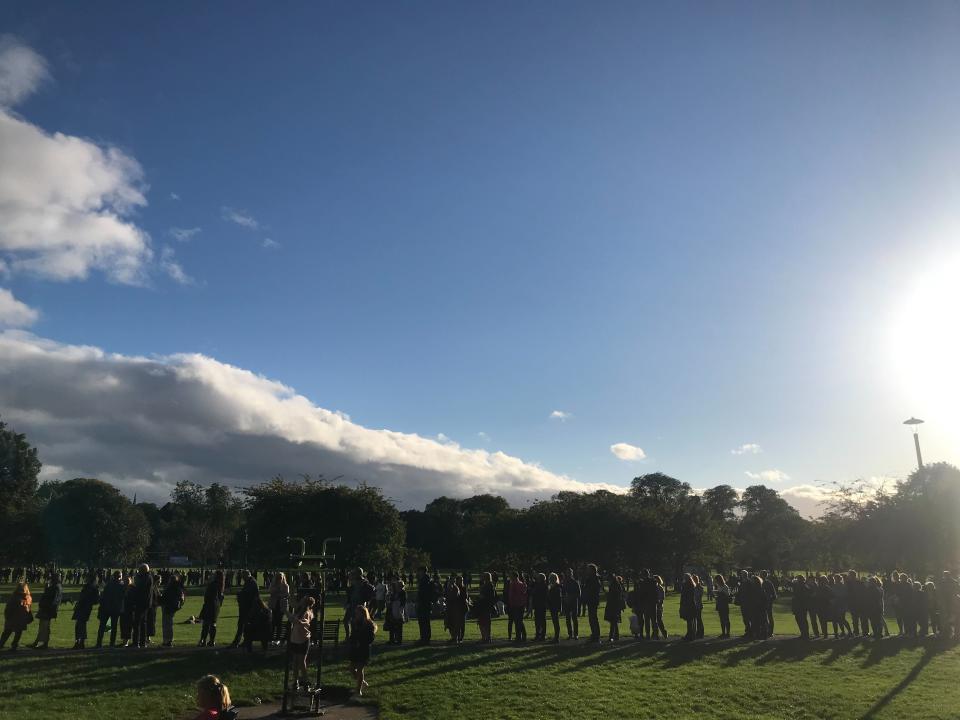 Queues for St Giles’ Cathedral line the walkways through the Edinburgh Meadows (Holly Bancroft/The Independent)