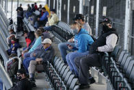 Fans watch a practice session for the IndyCar auto race at Indianapolis Motor Speedway, Thursday, Oct. 1, 2020, in Indianapolis. (AP Photo/Darron Cummings)