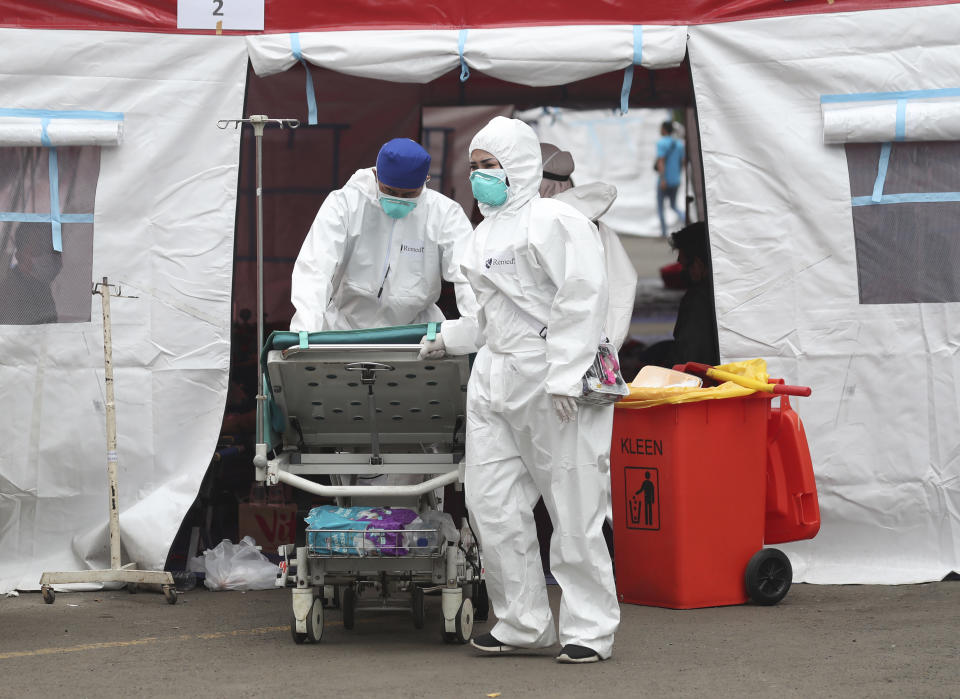 A bed it rolled out from an emergency tent erected to accommodate a surge of COVID-19 patients at a hospital in Bekasi, West Java, Indonesia, Monday, June 28, 2021. (AP Photo/Achmad Ibrahim)