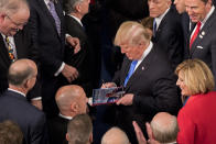 <p>Trump signs a copy of “Let Trump Be Trump” after delivering his first State of the Union address to a joint session of Congress at the U.S. Capitol in Washington, D.C., on Jan. 30. (Photo: Aaron P. Bernstein/Bloomberg via Getty Images) </p>