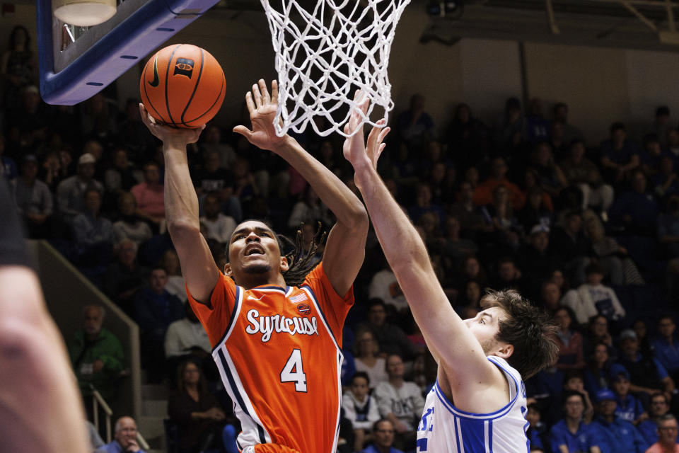 Syracuse's Chris Bell (4) shoots next to Duke's Ryan Young, right, during the first half of an NCAA college basketball game in Durham, N.C., Tuesday, Jan. 2, 2024. (AP Photo/Ben McKeown)