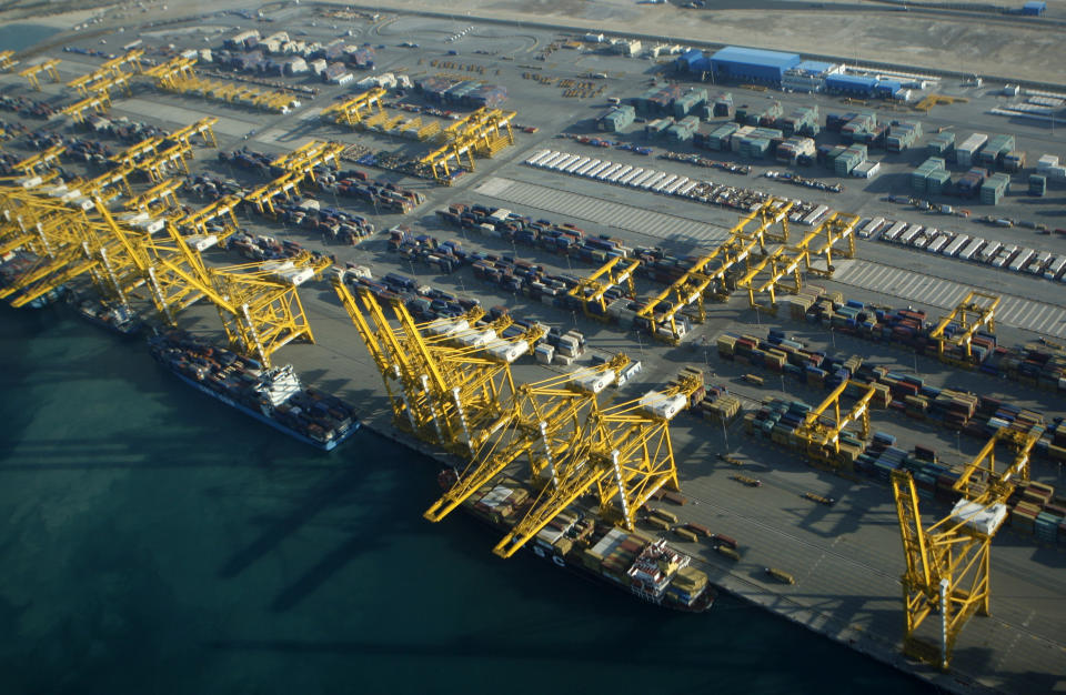 FILE - In this Sunday, Jan. 3, 2010 file photo, container ships dock at the Dubai Port in the Jebel Ali Free Zone about 40 kilometers (25 miles) south of Dubai, United Arab Emirates. Authorities in Dubai say a container ship anchored at its huge port caught fire, causing an explosion that sent tremors across the commercial hub of the United Arab Emirates. The Twitter post from Dubai’s state-run media office said the fire was reported on the ship late Wednesday, July 7, 2021. (AP Photo/Kamran Jebreili, File)