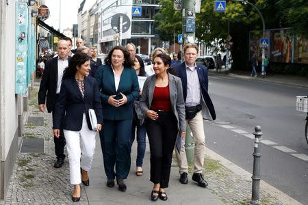 German Labour Minister Andrea Nahles (C), Cansel Kiziltepe (L), member of the German parliament, and Ayse Demi (R), spokesperson of the Turkish Federation Berlin (Tuerkischer Bund Berlin), walk through Berlin's Kreuzberg district, Germany, August 18, 2016. REUTERS/Axel Schmidt