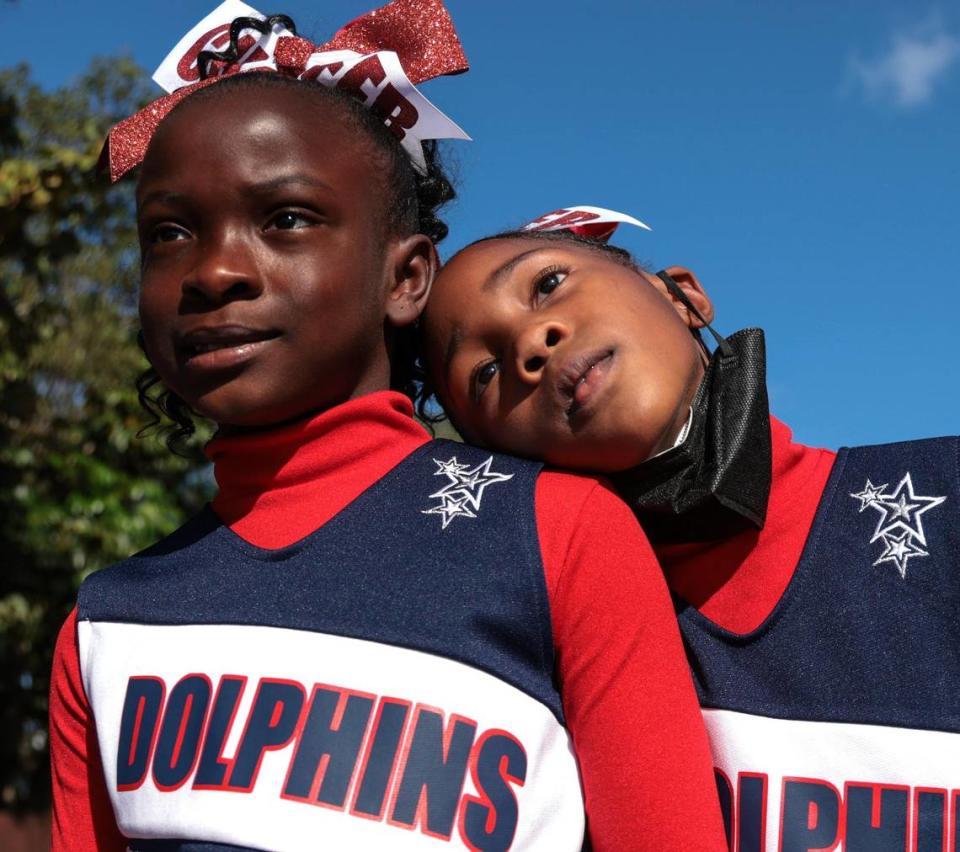 Agenoria S. Paschal / Olinda Elementary School second-graders Tamera Green, 8, left, and Serenity Spain, 8, right, who are also cousins, take a pause from parade practice while waiting for its start. The 45th Annual MLK Parade traveled westbound on Northwest 54th Street starting on 12th Avenue featuring college and high school marching bands, politicians, City of Miami mounted police and motor units, police color guards, city and county fire/rescue trucks, Miami-Dade transit workers, and others on Monday, Martin Luther King Jr. Day, Jan. 17, 2022.