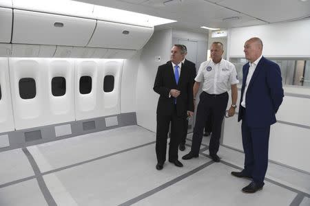 International Trade Secretary Liam Fox (L) views a passenger cabin crew simulator during his visit to EDM Ltd in Newton Heath, Manchester, Britain September 29, 2016. REUTERS/Anthony Devlin