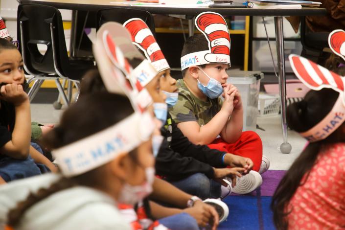 Pre-K students listen to volunteers read them books from Dr. Seuss at West Oso ISD's John F. Kennedy Elementary for Read Across America Day Wednesday, March 2, 2022.