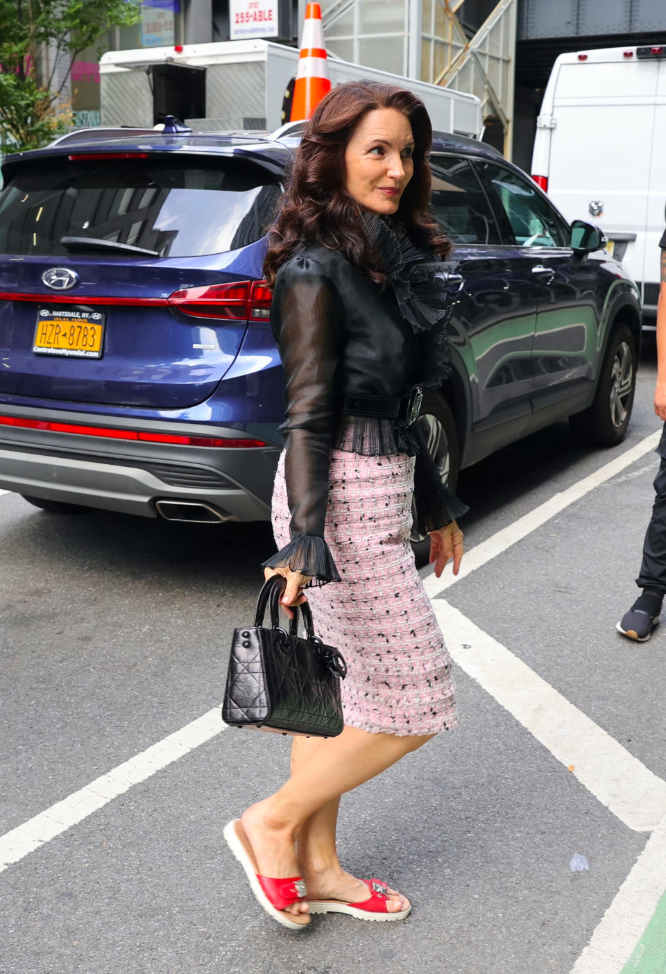 Kristin Davis is seen on the set of "And Just Like That..." in New York City wearing the Mules Coral Ginni from Dr. Scholl’s.