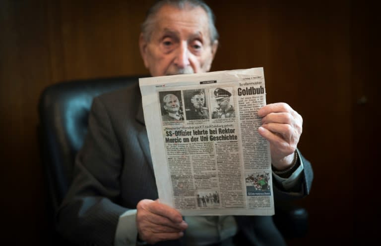 Marko Feingold, 104 years old, poses with a newspaper article at the Israeli Cultural Centre in Salzburg, Austria on March 15, 2018