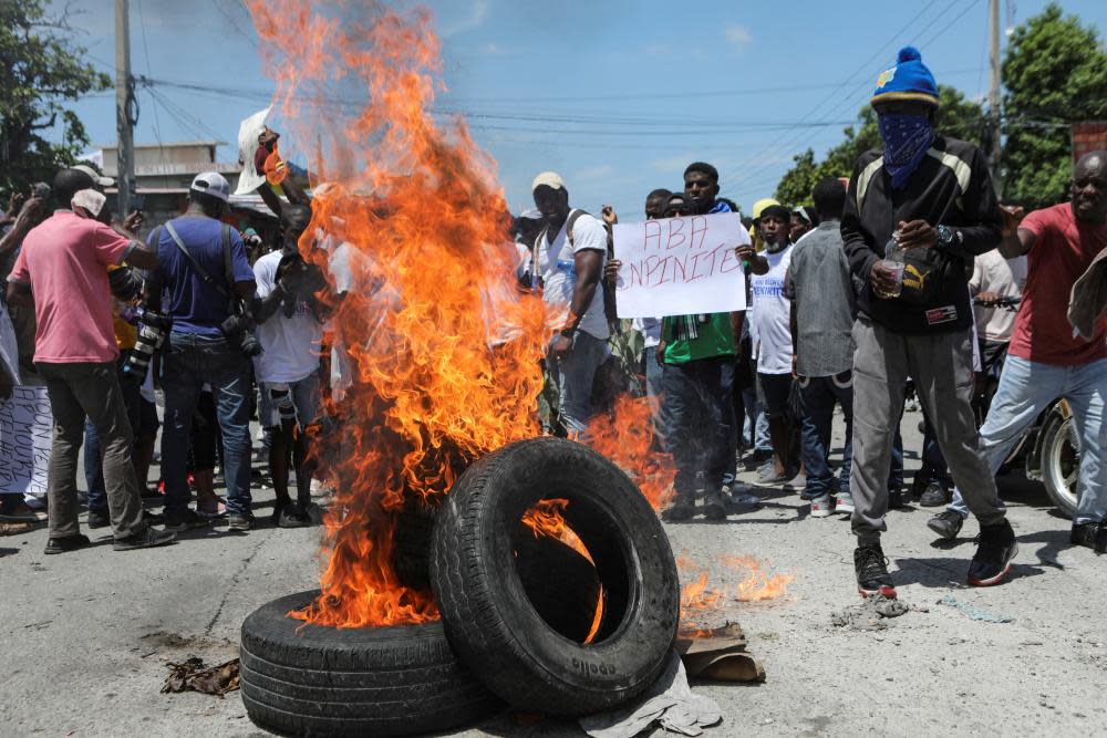 A demonstrator holds a banner which reads ‘Down with the impunity’ during a protest against insecurity and demands for the resignation of Prime Minister Ariel Henry in Port-au-Prince, Haiti, on 17 September 2023.