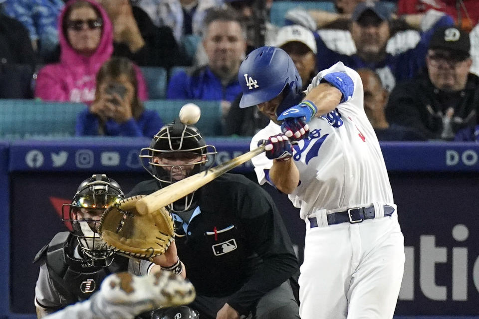 Los Angeles Dodgers' Chris Taylor, right, hits a grand slam as Chicago White Sox catcher Yasmani Grandal, left, and home plate umpire Jacob Metz watch during the sixth inning of a baseball game Thursday, June 15, 2023, in Los Angeles. (AP Photo/Mark J. Terrill)