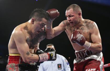 Mike Alvarado, right, exchanges punches with Brandon Rios during a WBO super lightweight title fight last year. (AP)