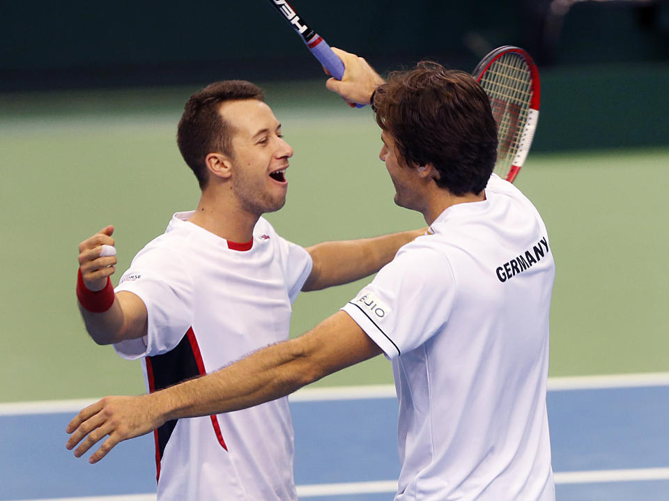 Germany's double Philipp Kohlschreiber, left, and Tommy Haas celebrate after beating Spain's Fernando Verdasco and David Marrero during a Davis Cup World Group first round tennis match between Germany and Spain in Frankfurt, Germany, Saturday, Feb. 1, 2014. Germany has now a 3-0 lead and advances to the next round. (AP Photo/Michael Probst)