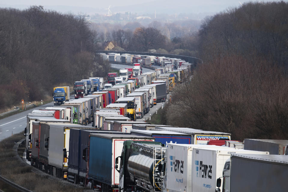 Trucks are jammed on the motorway A4 near Bautzen, Germany, Tuesday, March 17, 2020. Because of the controls at the border with Poland, a traffic jam formed on the Autobahn 4 between Dresden and Goerlitz, which, according to police, had grown to a length of 40 kilometers by noon. For most people, the new coronavirus causes only mild or moderate symptoms, such as fever and cough. For some, especially older adults and people with existing health problems, it can cause more severe illness, including pneumonia. (Robert Michael/dpa via AP)