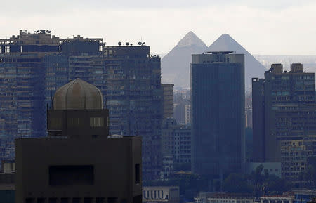 The U.S embassy (L) building and the Giza Pyramids are pictured behind buildings near Tahrir square in downtown Cairo, Egypt October 31, 2016. Picture taken October 31, 2016. REUTERS/Amr Abdallah Dalsh