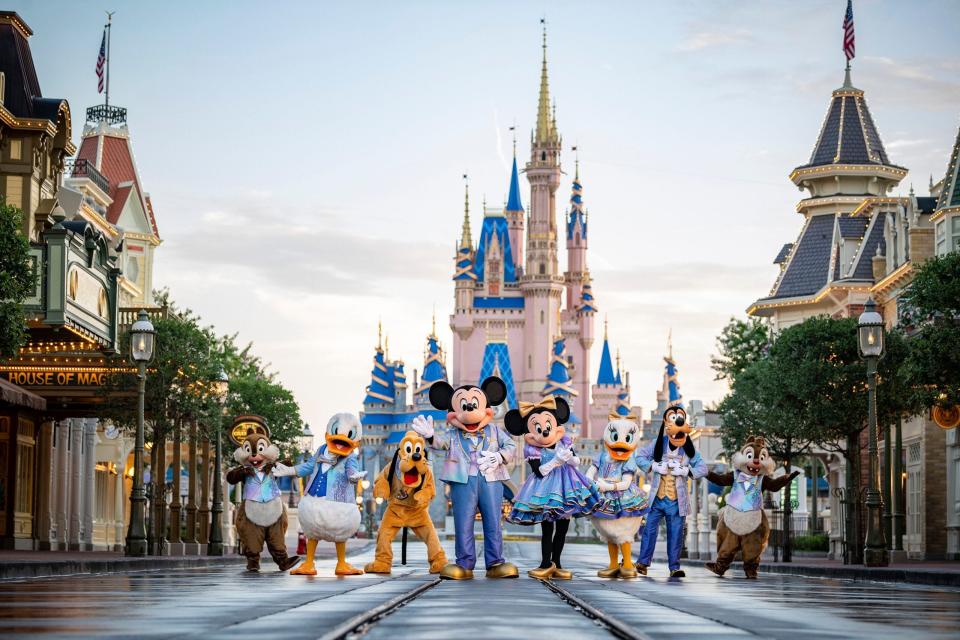 Mickey Mouse, Minnie Mouse and other iconic Disney characters stand in front of Cinderella Castle at the Magic Kingdom theme park in Walt Disney World, near Orlando.