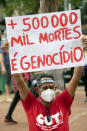 A man, wearing a protective face mask, holds a sign with a message that reads in Portuguese; "500,000 deaths is genocide", during a protest against Brazilian President Jair Bolsonaro and his handling of the pandemic and economic policies protesters say harm the interests of the poor and working class, in Cuiaba, Brazil, Saturday, June 19, 2021. Brazil is approaching an official COVID-19 death toll of 500,000 — second-highest in the world.(AP Photo/Andre Penner)