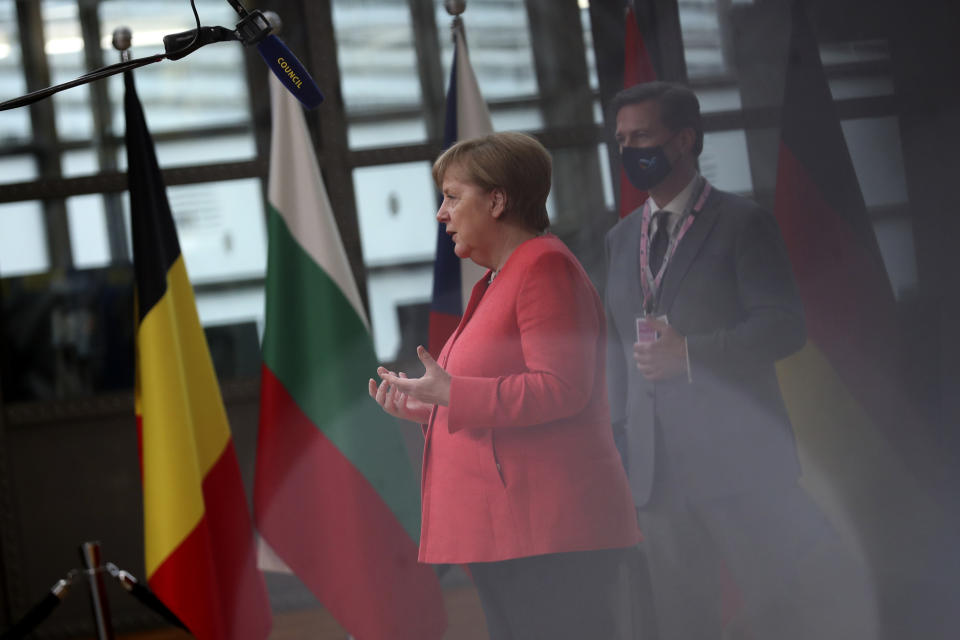 German Chancellor Angela Merkel makes a statement as she arrives for an EU summit at the European Council building in Brussels, Friday, July 17, 2020. Leaders from 27 European Union nations meet face-to-face on Friday for the first time since February, despite the dangers of the coronavirus pandemic, to assess an overall budget and recovery package spread over seven years estimated at some 1.75 trillion to 1.85 trillion euros. (AP Photo/Francisco Seco, Pool)