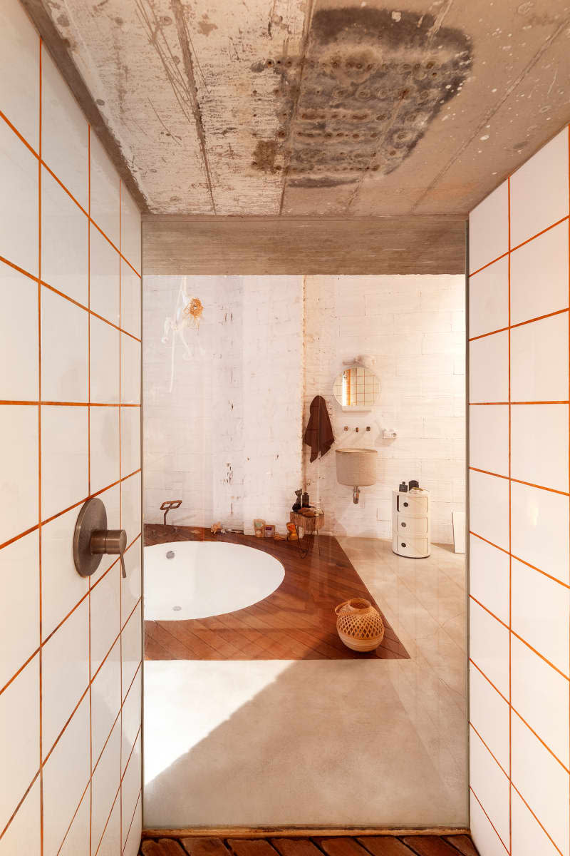 bathroom with white brick walls and wood accents