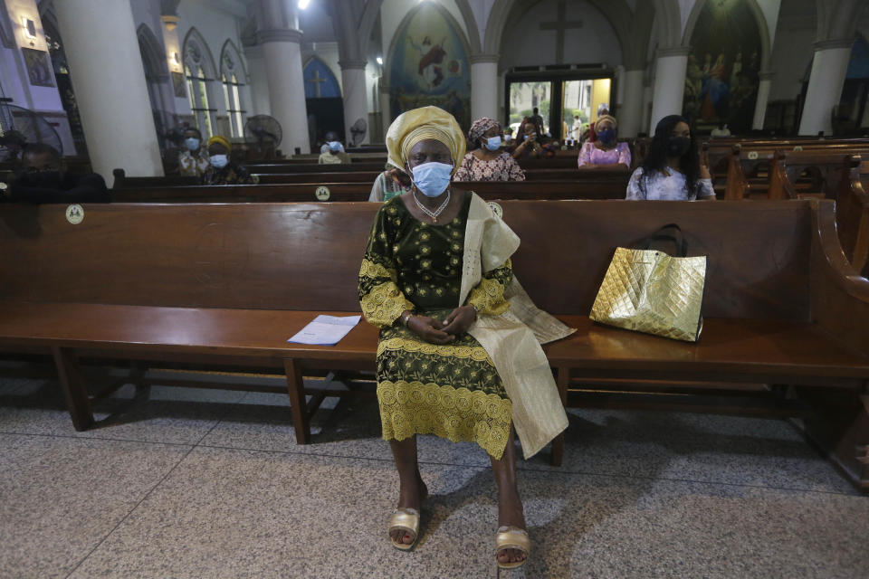 Parishioners wearing face mask to protect against coronavirus, attend a morning Christmas Mass at Holy Cross Cathedral in Lagos, Nigeria, Friday Dec. 25, 2020. Africa's top public health official says another new variant of the coronavirus appears to have emerged in Nigeria, but further investigation is needed. The discovery could add to new alarm in the pandemic after similar variants were announced in recent days in Britain and South Africa and sparked the swift return of travel restrictions. (AP Photo/Sunday Alamba)