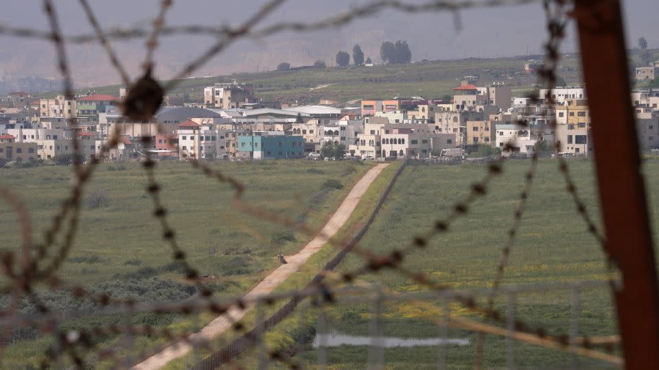 A view of the town of Ghajar taken from a Spanish UNIFIL base in Lebanon. It straddles Syrian and Lebanese territory and is occupied by Israel. A field sowed with mines buffers Lebanese-controlled territory from the Israeli-constructed fence. - Charbel Mallo/CNN