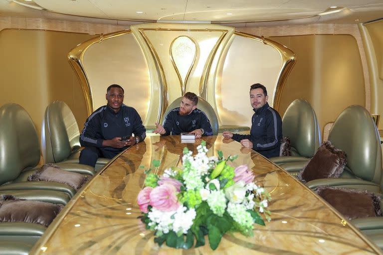 Odion Ighalo, junto a dos compañeros, en una sala de reuniones dentro del avión que traslada al Al-Hilal.  