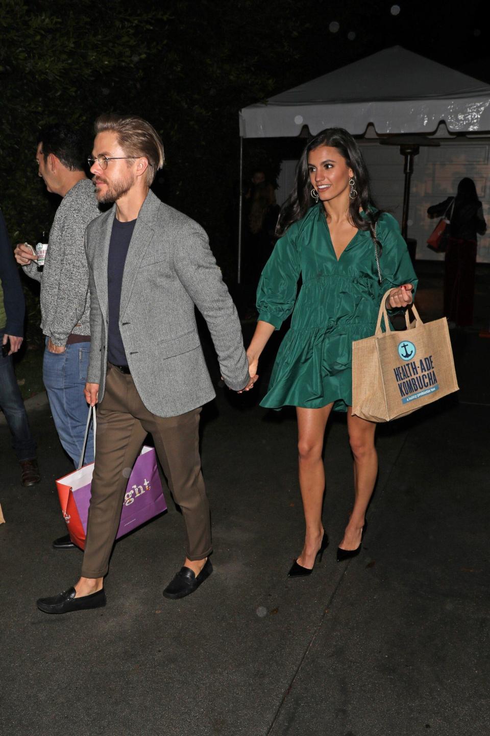 Derek Hough and girlfriend Hayley Erbert walk hand in hand as they leaving an event