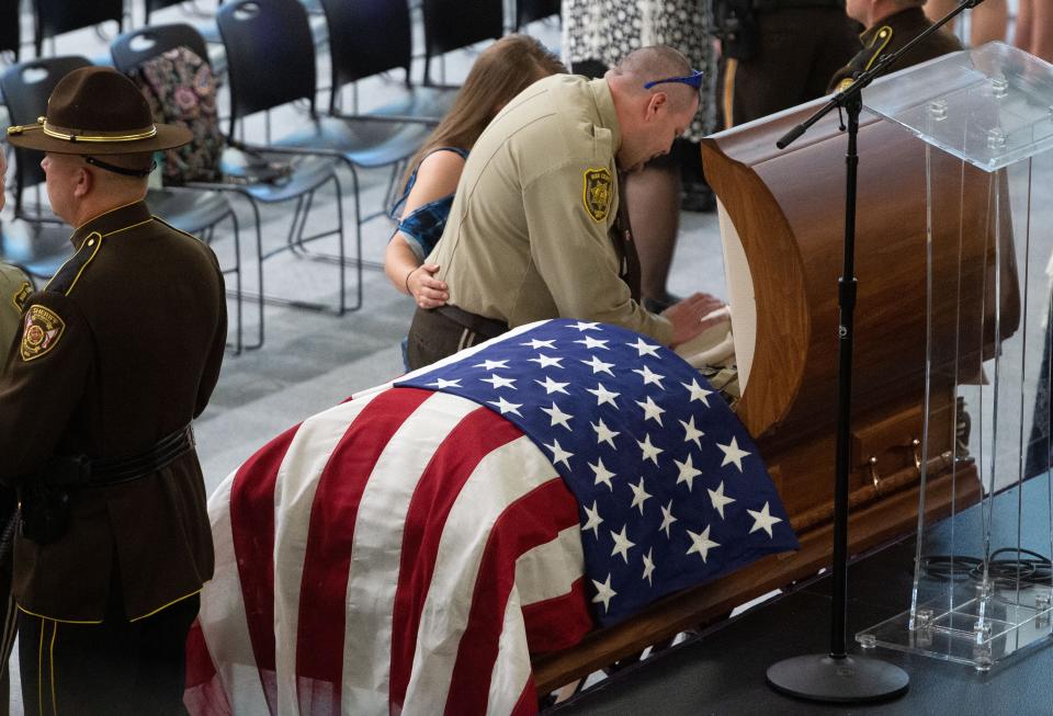 July 08, 2022; Montevallo, AL, USA; Deputy Chris Poole, who was shot in the same incident that claimed the life of  Bibb County Deputy Brad Johnson, pays his respects during Johnson’s visitation at the University of Montevallo Student Activity Center.  Gary Cosby Jr.-The Tuscaloosa News