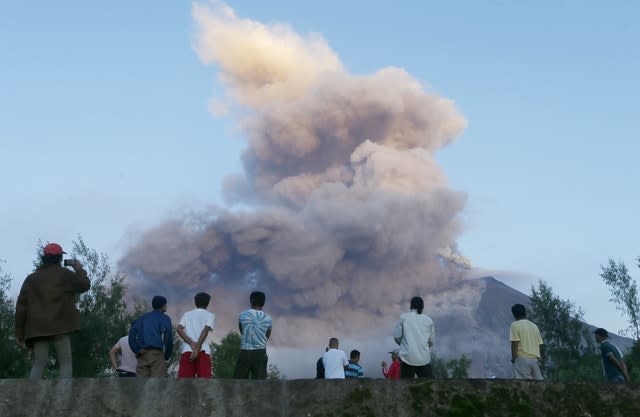 Residents watch as the Mayon volcano erupts anew as seen from Legazpi city, Albay province, around 200 miles south east of Manila, Philippines, in 2018