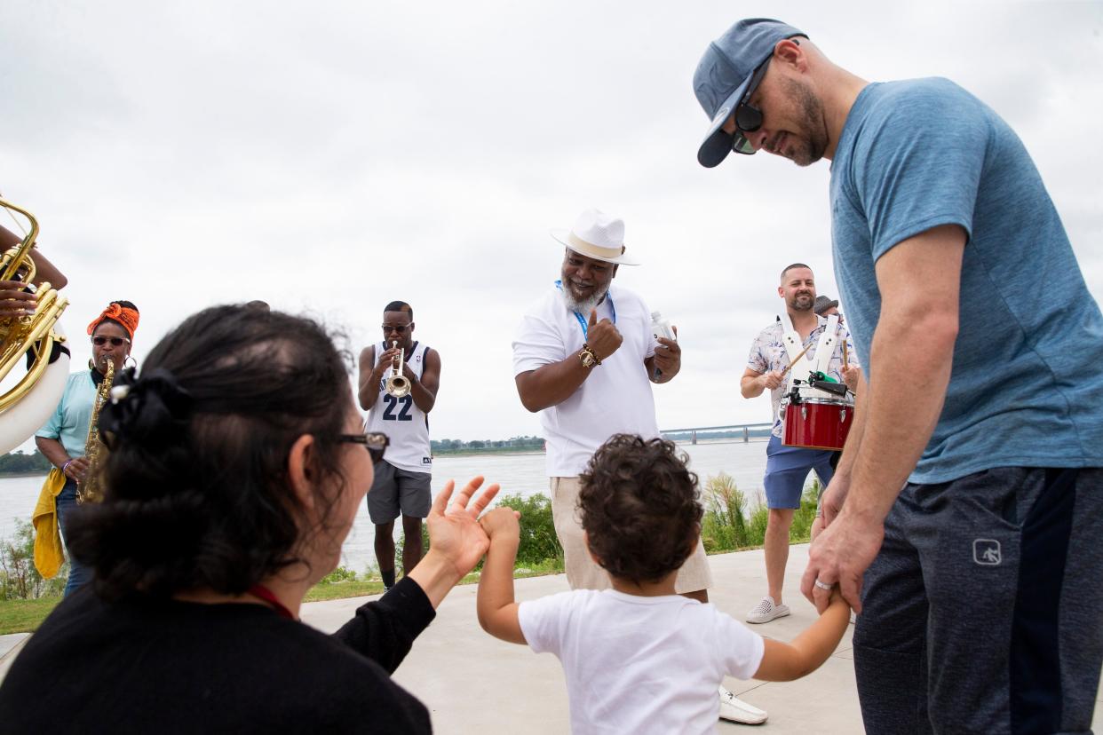 State Rep. Antonio Parkinson dances to the Lucky Seven Brass Band along with Ezra Duberow, 2, and his parents Karla and Eli Duberow in the newly renovated Tom Lee Park shortly after it officially opened to the public in Downtown Memphis on Saturday, September 2, 2023.